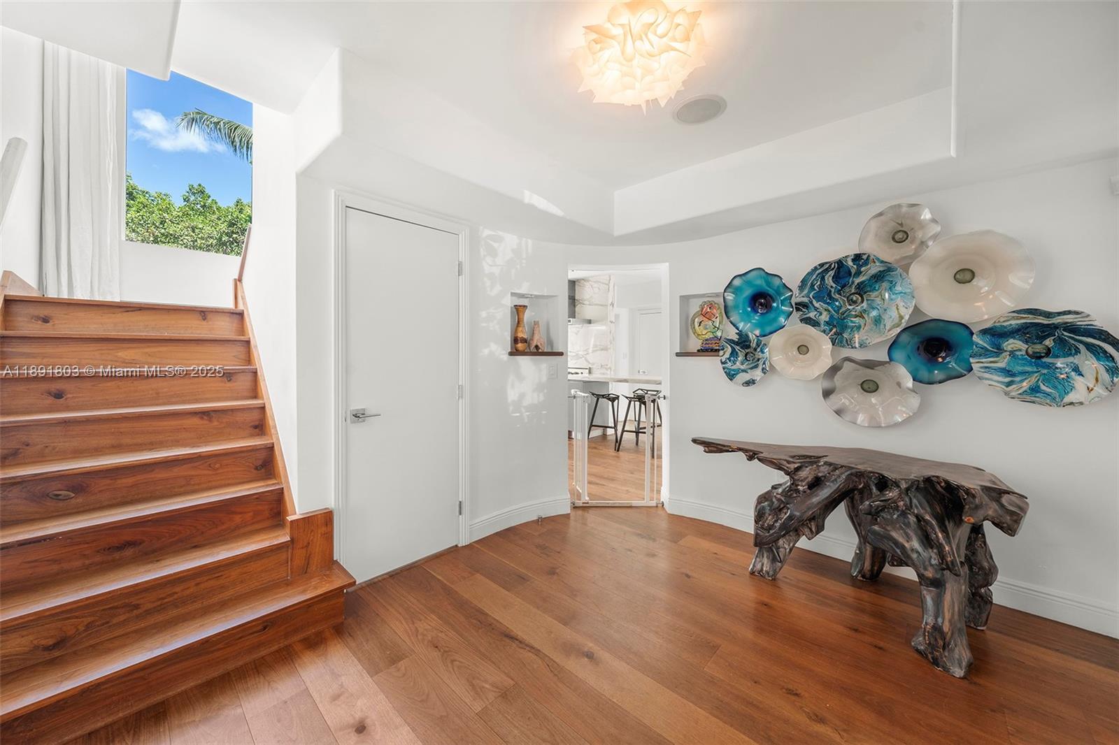 2701 North Bay Road Miami Beach, FL 33140 - Photo 19 of 38 a view of a room with wooden floor and table