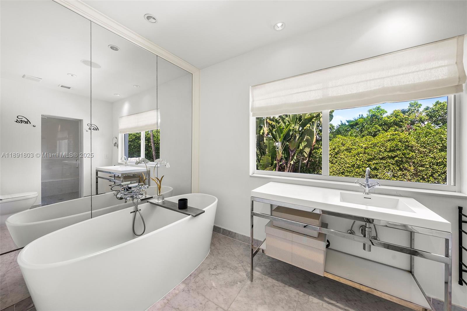 2701 North Bay Road Miami Beach, FL 33140 - Photo 25 of 38 a bathroom with a bathtub and next to a window