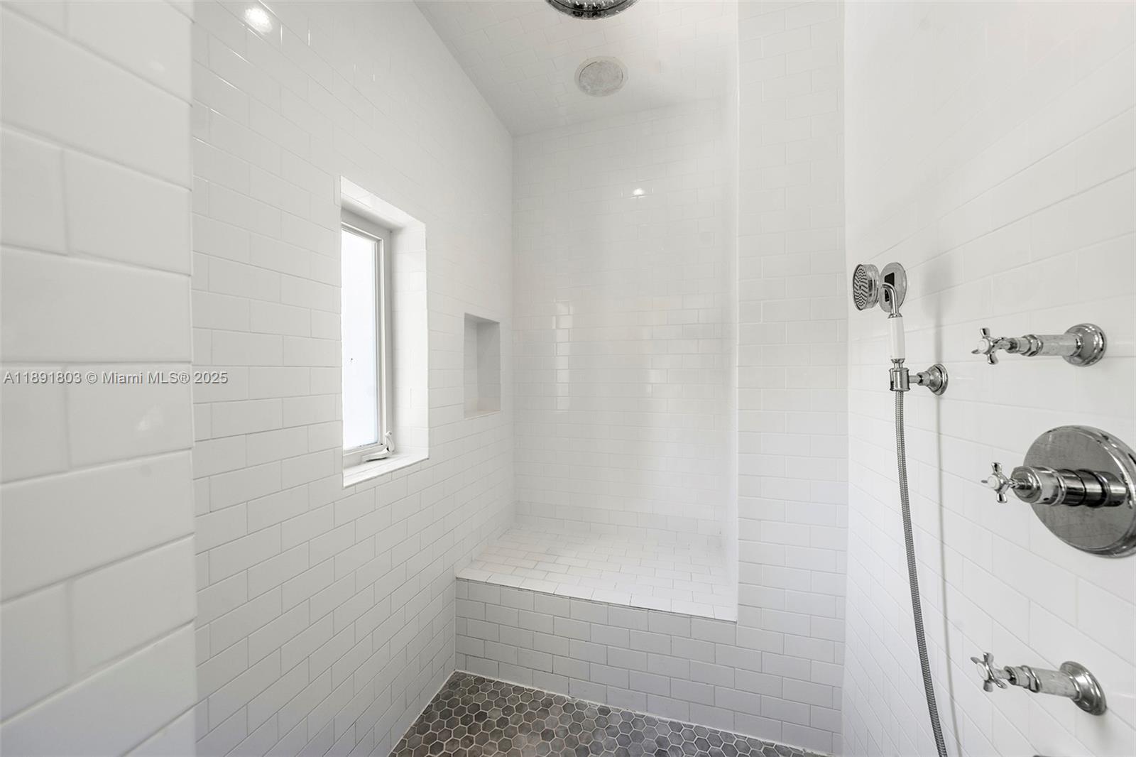 2701 North Bay Road Miami Beach, FL 33140 - Photo 26 of 38 a bathroom with a tub and a window