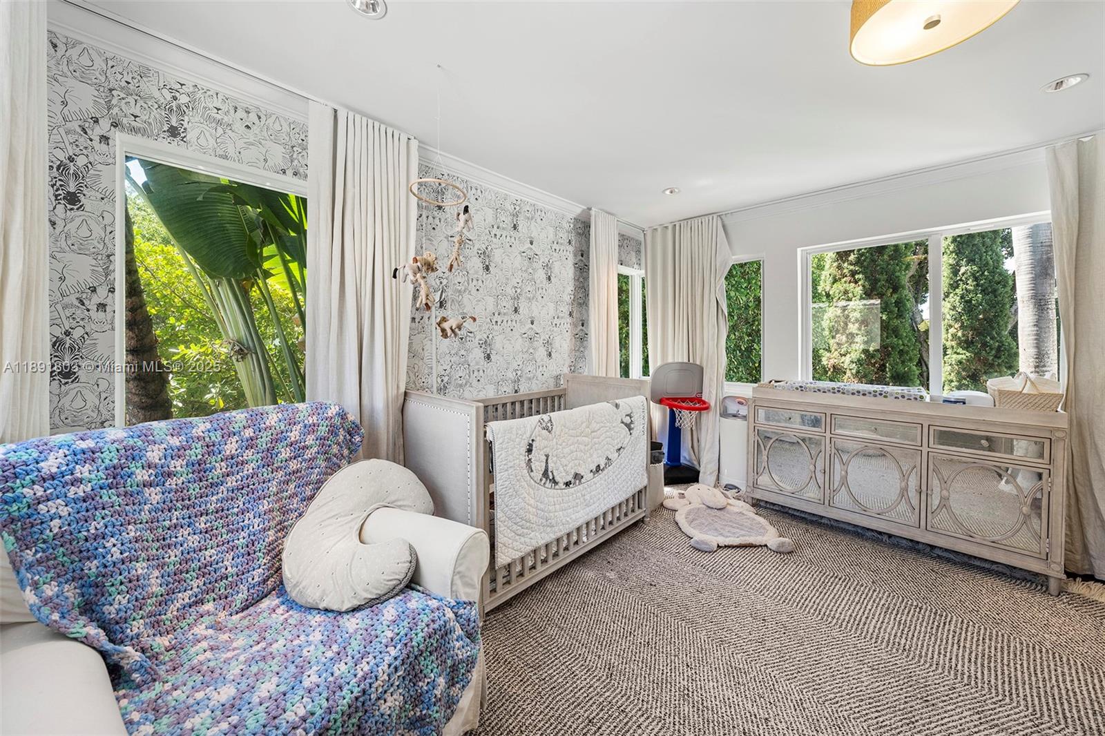 2701 North Bay Road Miami Beach, FL 33140 - Photo 27 of 38 a bedroom with furniture and a large window