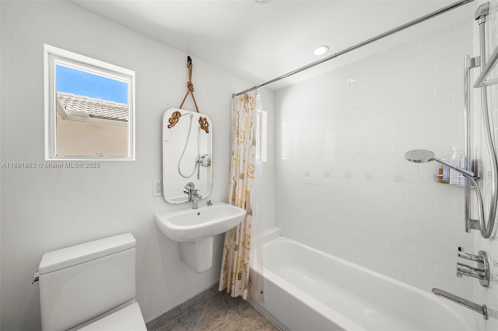 2701 North Bay Road Miami Beach, FL 33140 - Photo 28 of 38 a bathroom with a sink a toilet and shower