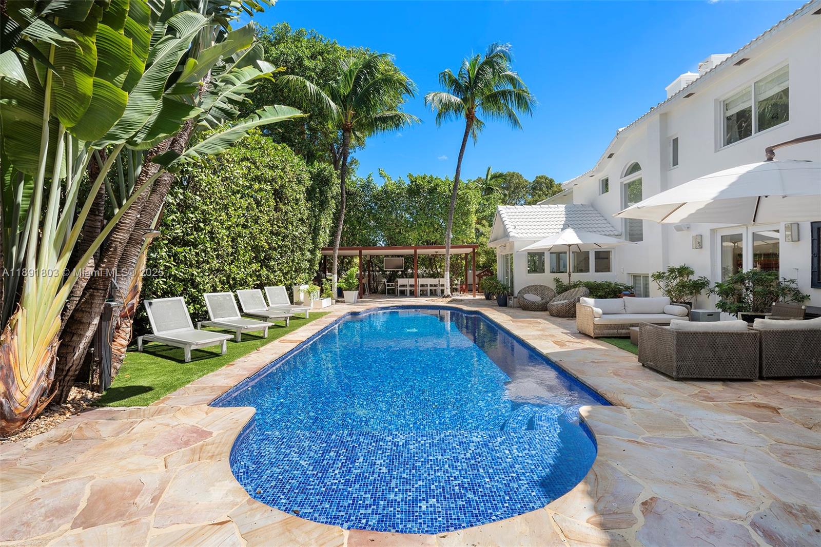 2701 North Bay Road Miami Beach, FL 33140 - Photo 3 of 38 a view of a swimming pool with a patio