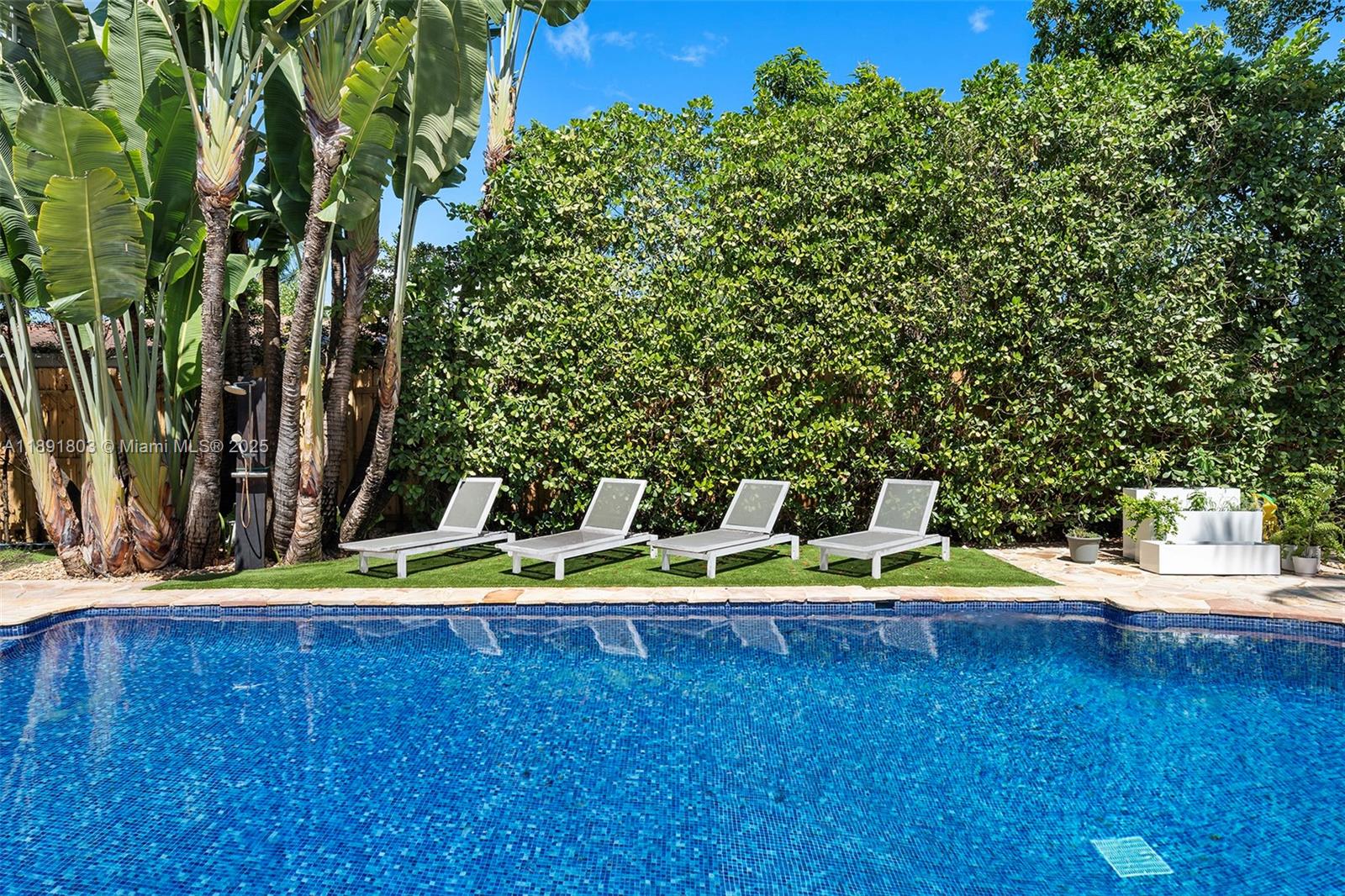 2701 North Bay Road Miami Beach, FL 33140 - Photo 4 of 38 a view of a small yard with wooden fence