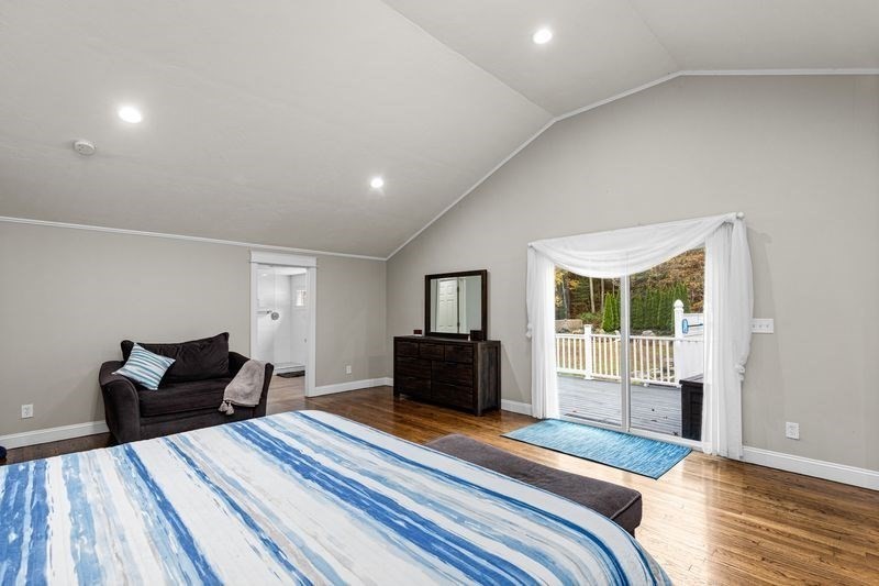 242 Hedges Pond Road Plymouth, MA 02360 - Photo 14 of 38 a bedroom with a bed and wooden floor
