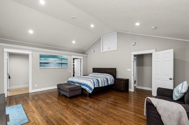 242 Hedges Pond Road Plymouth, MA 02360 - Photo 16 of 38 a spacious bedroom with a bed and wooden floor