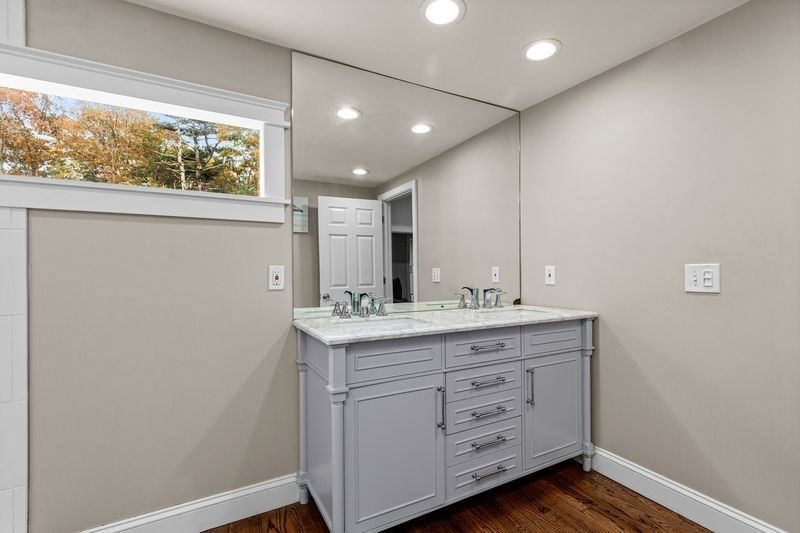 242 Hedges Pond Road Plymouth, MA 02360 - Photo 18 of 38 a bathroom with a double vanity sink and a window