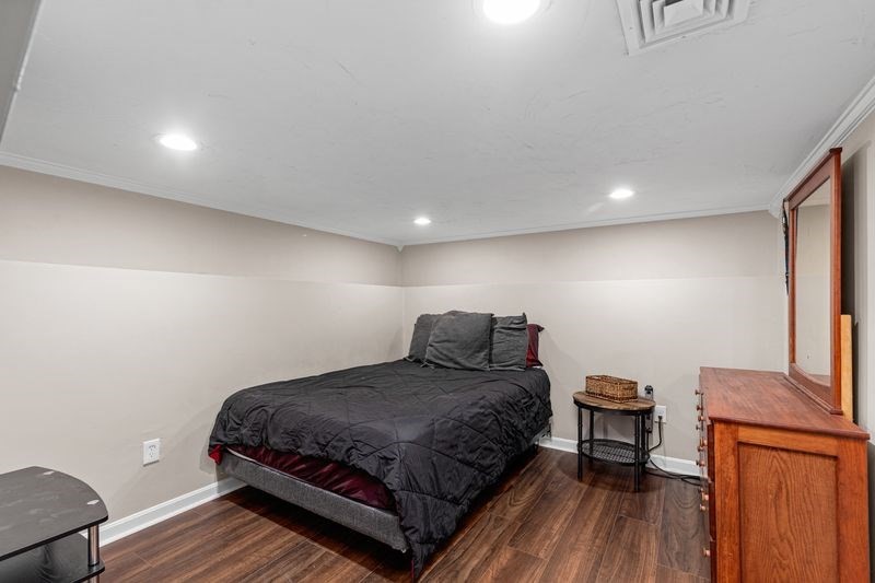 242 Hedges Pond Road Plymouth, MA 02360 - Photo 24 of 38 a bedroom with a bed and wooden floor