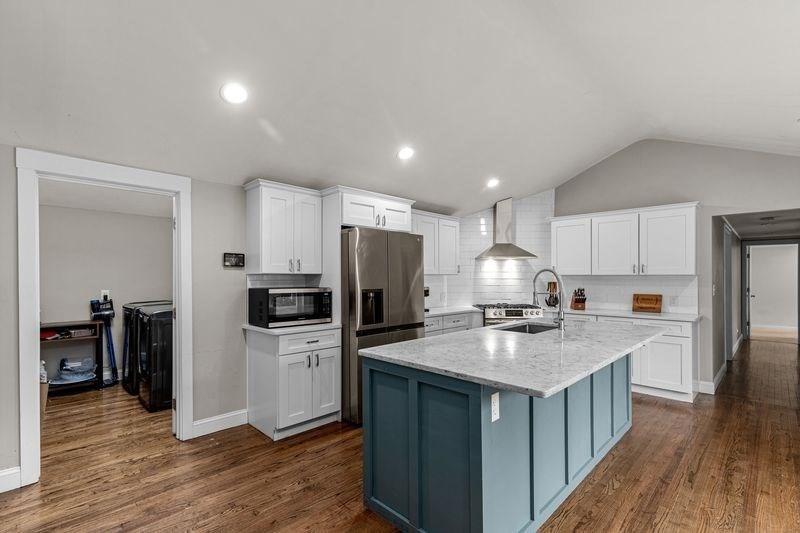 242 Hedges Pond Road Plymouth, MA 02360 - Photo 3 of 38 a kitchen with a refrigerator a sink dishwasher and a stove with wooden floor