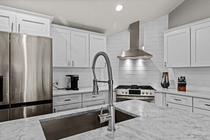 242 Hedges Pond Road Plymouth, MA 02360 - Photo 4 of 38 a kitchen with granite countertop a stove and a refrigerator