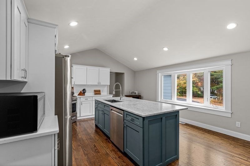 242 Hedges Pond Road Plymouth, MA 02360 - Photo 6 of 38 a kitchen with a stove sink and cabinets