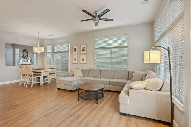 a view of a hallway with wooden floor and a bathroom