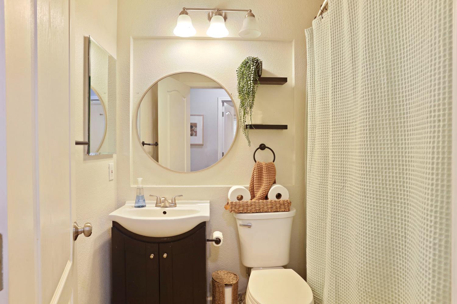 277 Fragrance Street Manteca, CA 95337 - Photo 15 of 27 a bathroom with a toilet sink and mirror