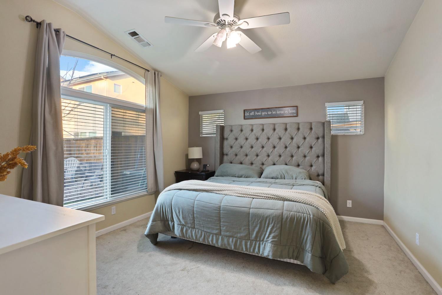 277 Fragrance Street Manteca, CA 95337 - Photo 16 of 27 a bedroom with a large bed and a chandelier