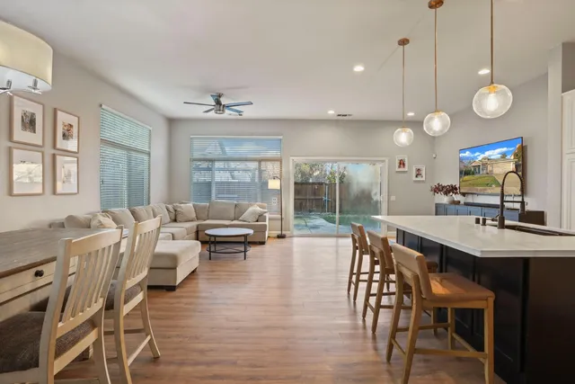 a kitchen with stainless steel appliances a stove a sink island and a refrigerator