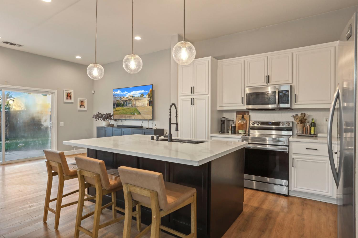 277 Fragrance Street Manteca, CA 95337 - Photo 2 of 27 a kitchen with stainless steel appliances a stove a sink island and a refrigerator
