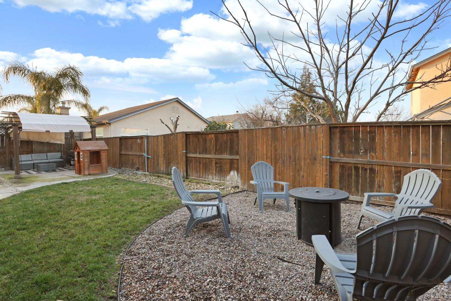 277 Fragrance Street Manteca, CA 95337 - Photo 25 of 27 a view of a chairs and table in backyard