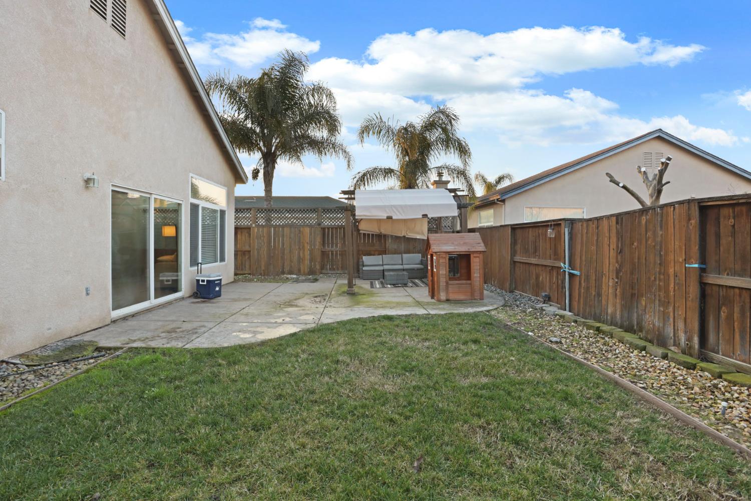 277 Fragrance Street Manteca, CA 95337 - Photo 27 of 27 a view of a house with a big yard and large tree