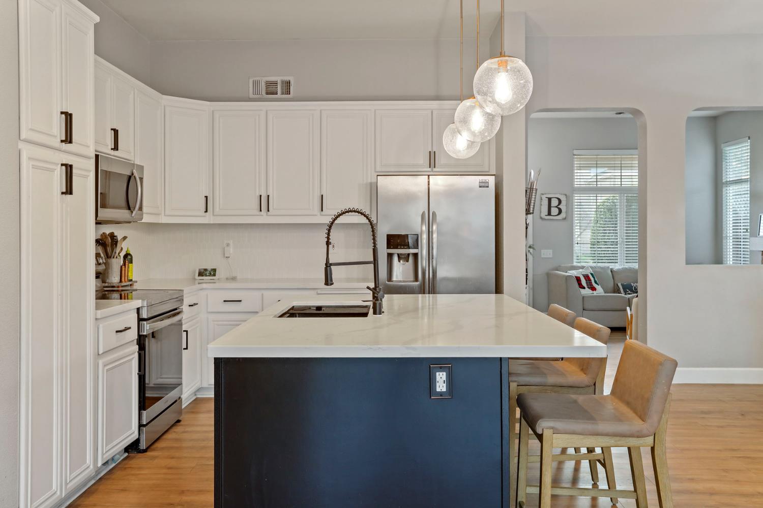 277 Fragrance Street Manteca, CA 95337 - Photo 6 of 27 a kitchen with a sink cabinets and stainless steel appliances