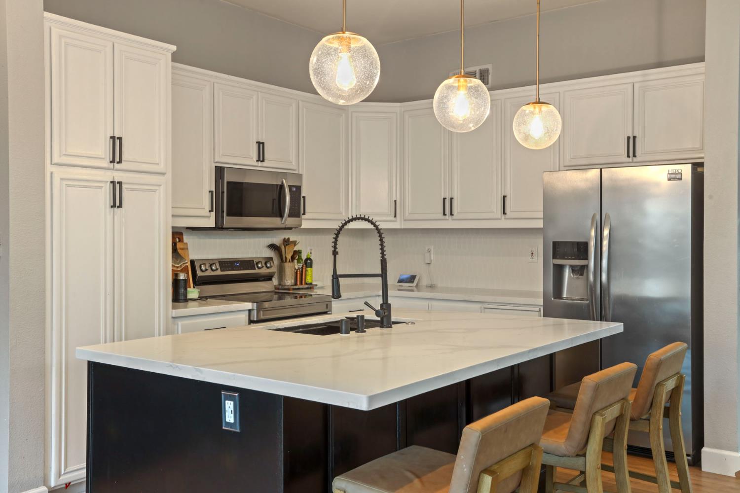 277 Fragrance Street Manteca, CA 95337 - Photo 7 of 27 a kitchen with cabinets stainless steel appliances and a counter top