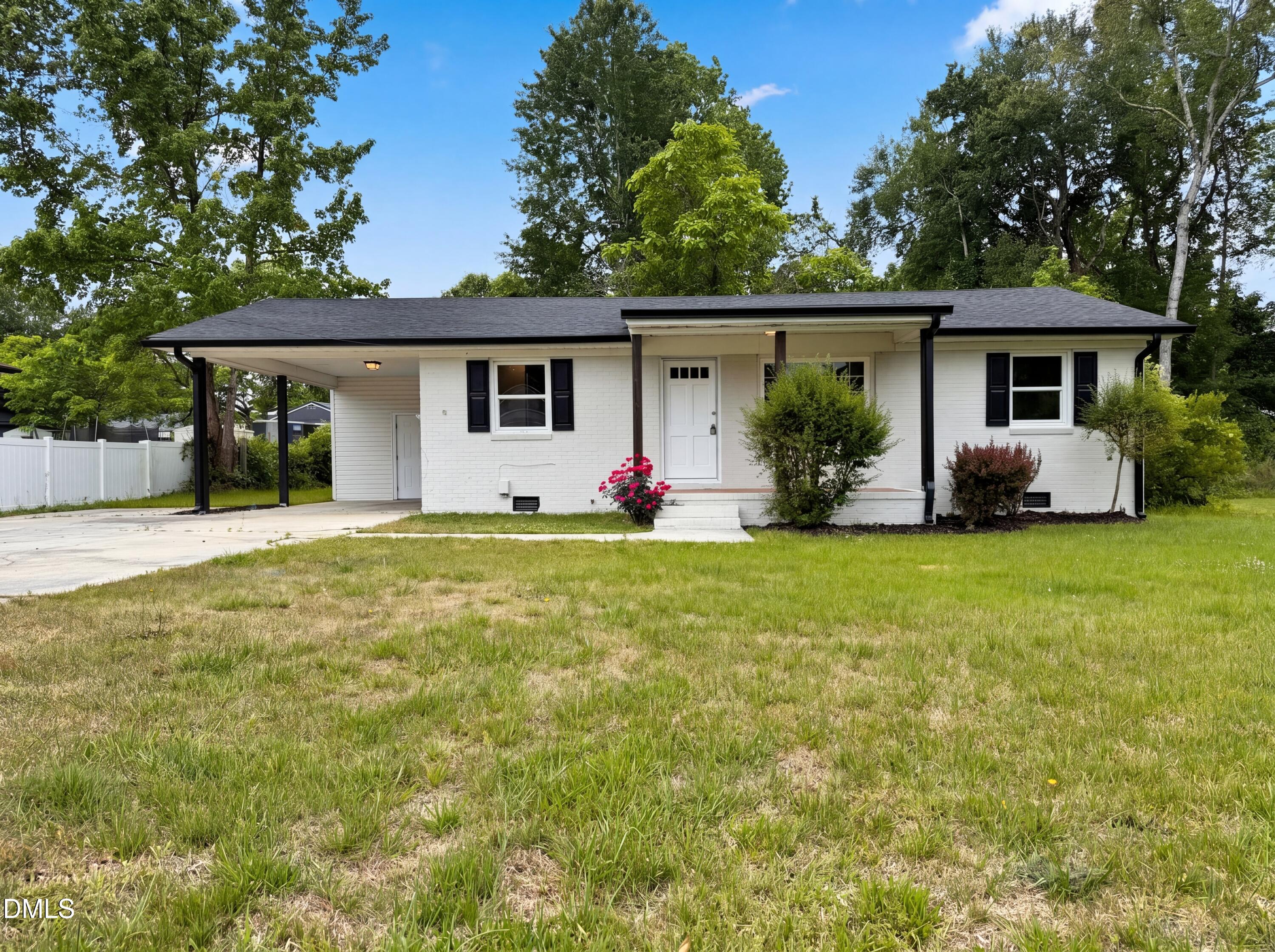 303 Stancil Street Smithfield, NC 27577 - Photo 1 of 16 a front view of house with yard seating and green space
