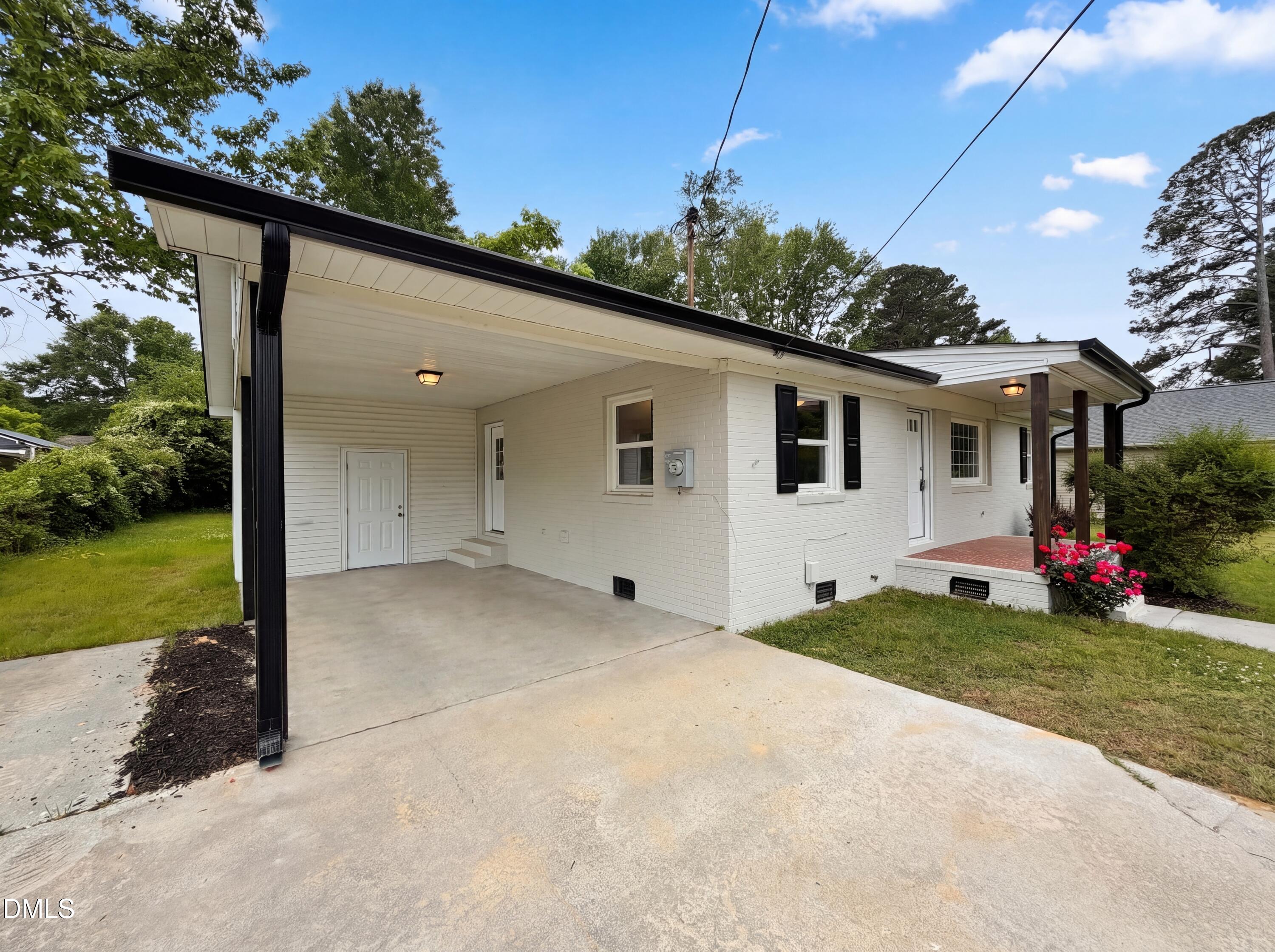 303 Stancil Street Smithfield, NC 27577 - Photo 14 of 16 a view of a white house with a yard