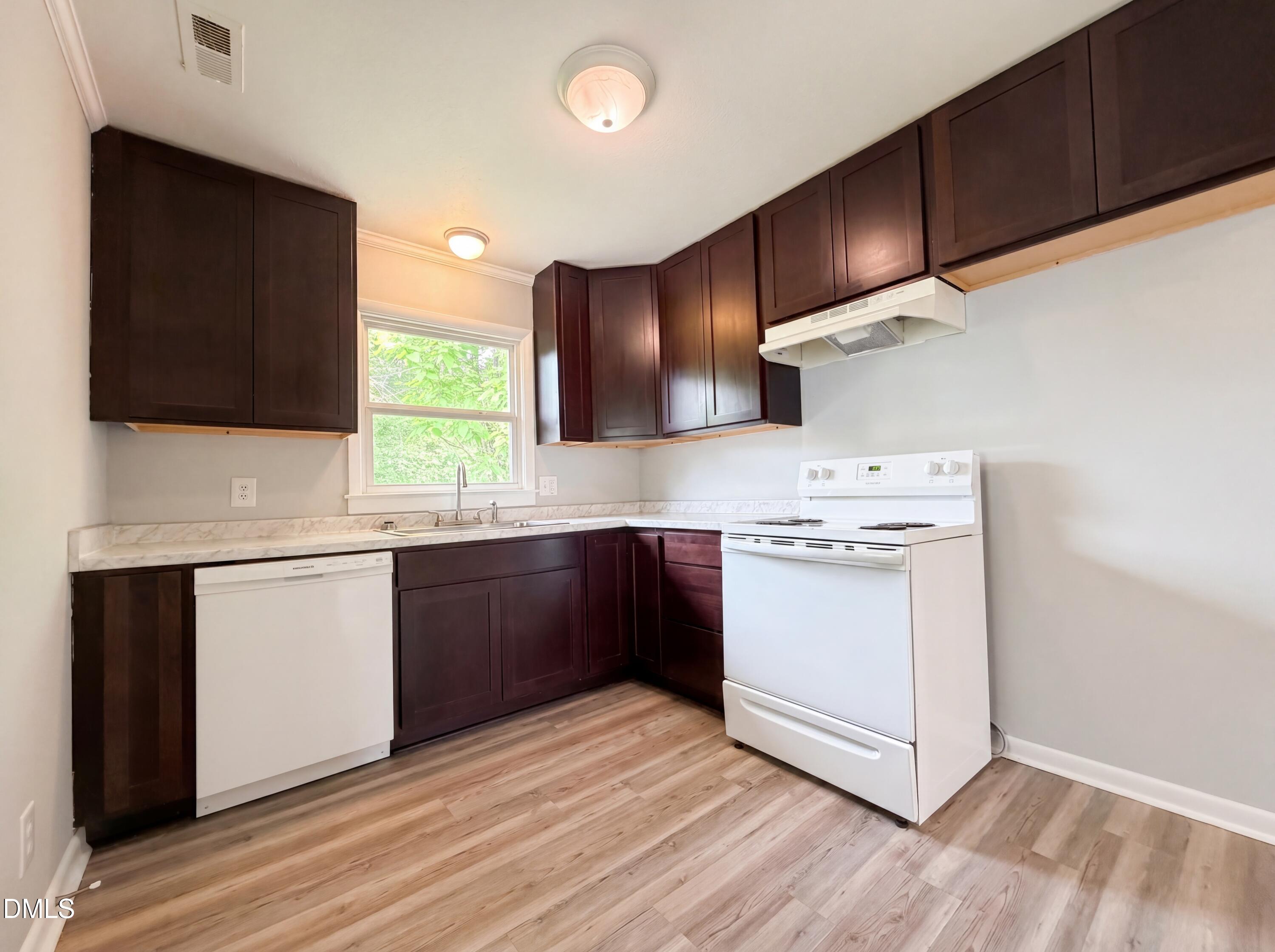 303 Stancil Street Smithfield, NC 27577 - Photo 2 of 16 a kitchen with a sink cabinets and window