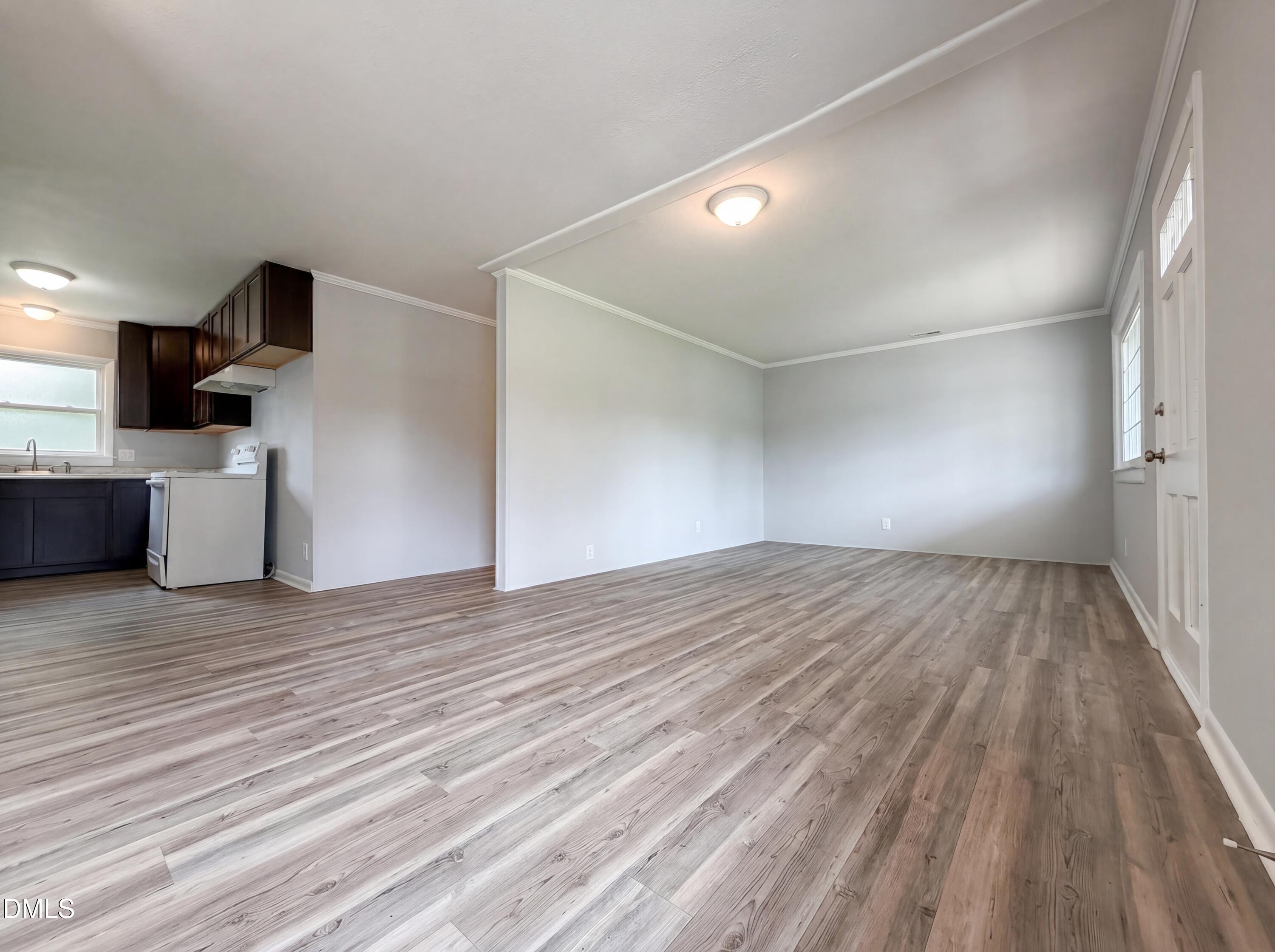 303 Stancil Street Smithfield, NC 27577 - Photo 3 of 16 a view of empty room with wooden floor and windows
