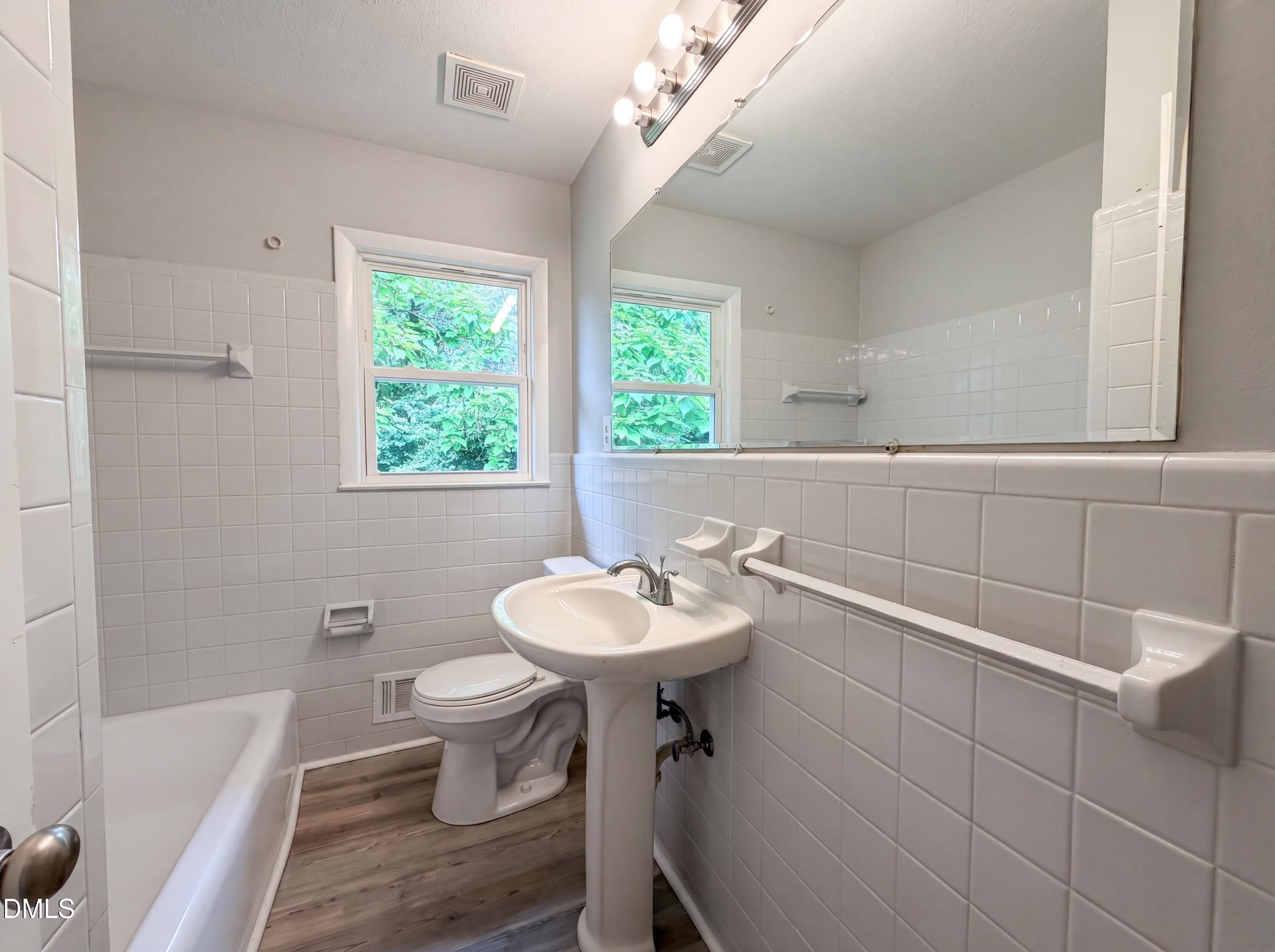 303 Stancil Street Smithfield, NC 27577 - Photo 6 of 16 a bathroom with a sink toilet and a bathtub