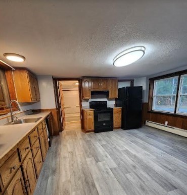 36 Brookfield Road Sturbridge, MA 01518 - Photo 5 of 9 a kitchen with stainless steel appliances kitchen island granite countertop a stove a sink and a refrigerator with wooden floor