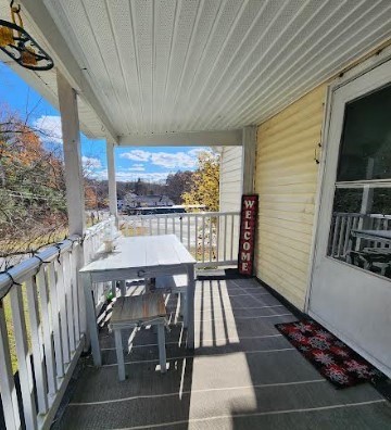 36 Brookfield Road Sturbridge, MA 01518 - Photo 8 of 9 a view of a patio with table and chairs with wooden floor and fence