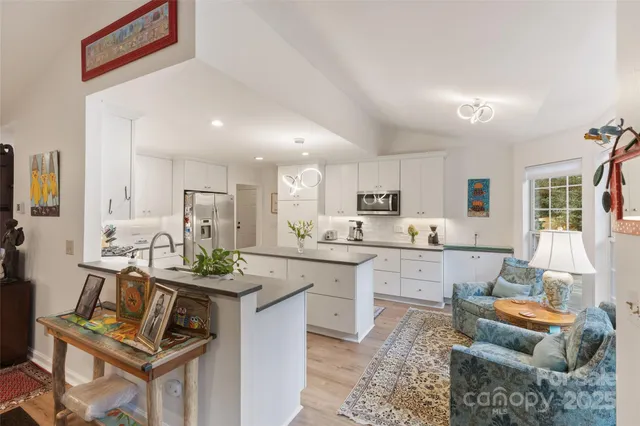 a kitchen with a sink a counter top stainless steel appliances and cabinets