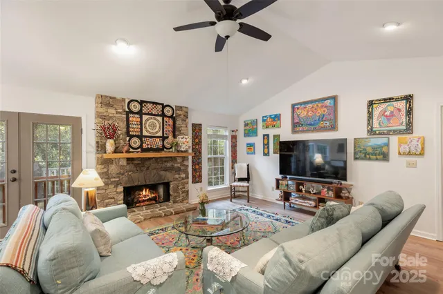 a living room with furniture flat screen tv and a fireplace