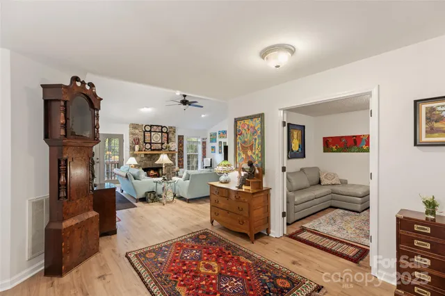 a living room with furniture kitchen view and a rug