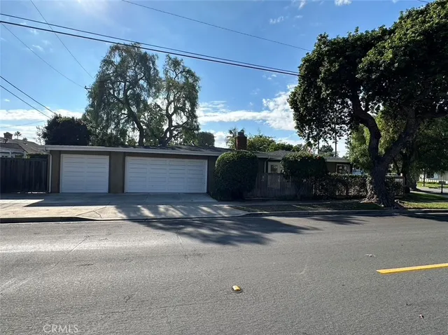 a front view of a house with trees