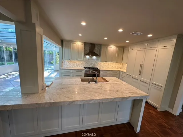 a large white kitchen with a large window