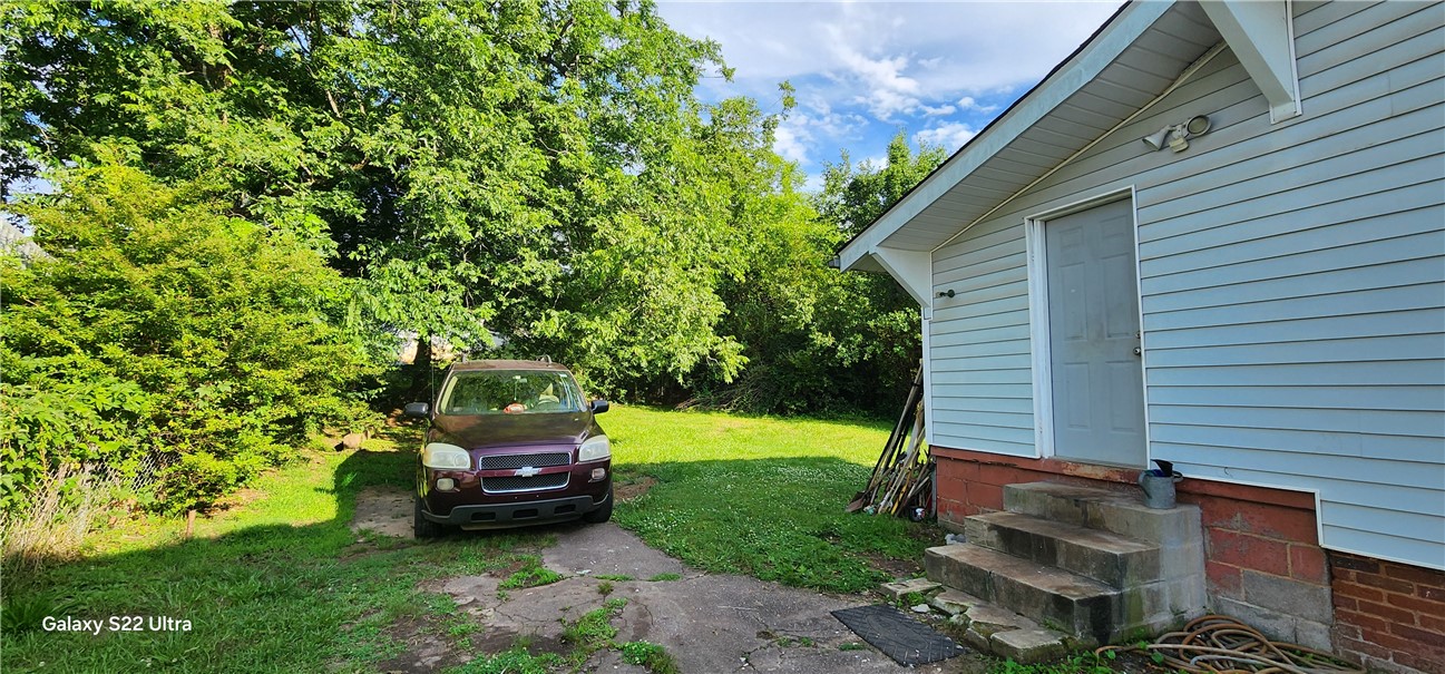 105 Hope Avenue Seneca, SC 29678 - Photo 28 of 33 A private entry leads to this home, offering a quiet, secluded feel amidst lush greenery.