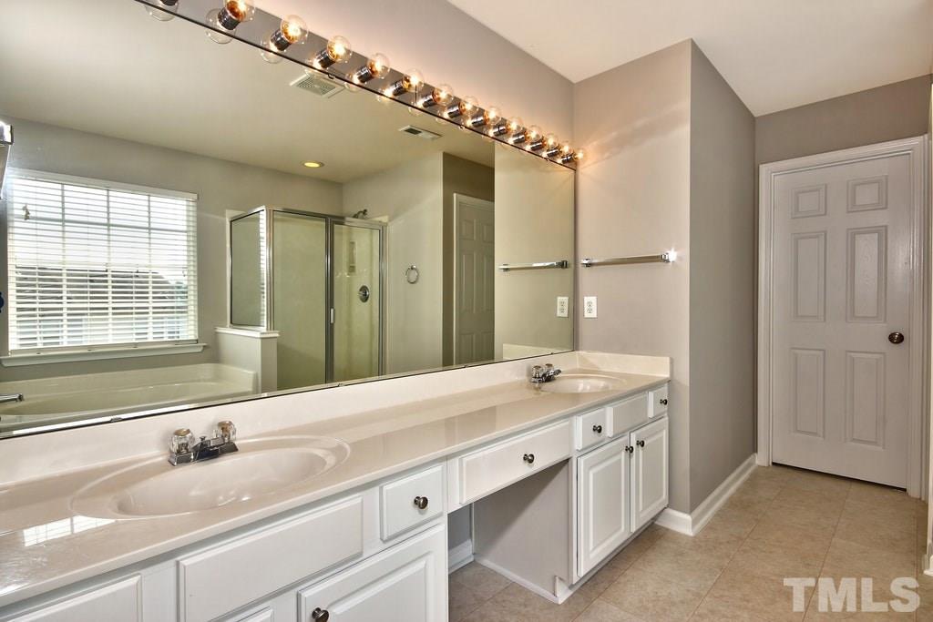 5307 Griffith Park Road Raleigh, NC 27613 - Photo 17 of 25 Double vanity so no fighting over counter space here! Separate water closet and stand alone shower along with the garden tub.
