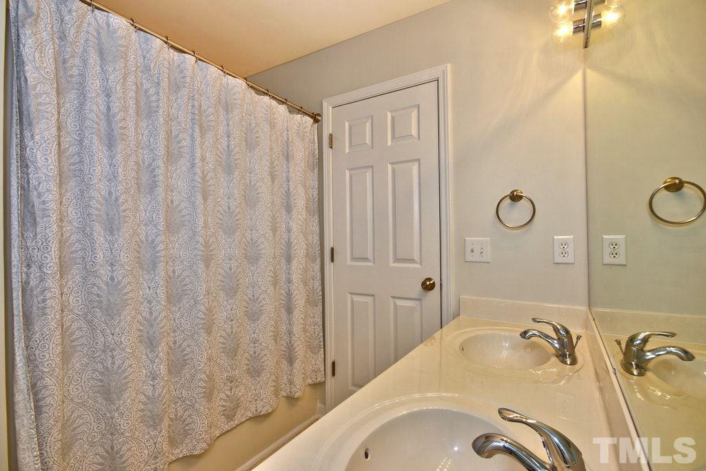 5307 Griffith Park Road Raleigh, NC 27613 - Photo 22 of 25 Full bath upstairs and another 1/2 bath downstairs. This bathroom in the hall can also be accessed directly from one of the bedrooms.