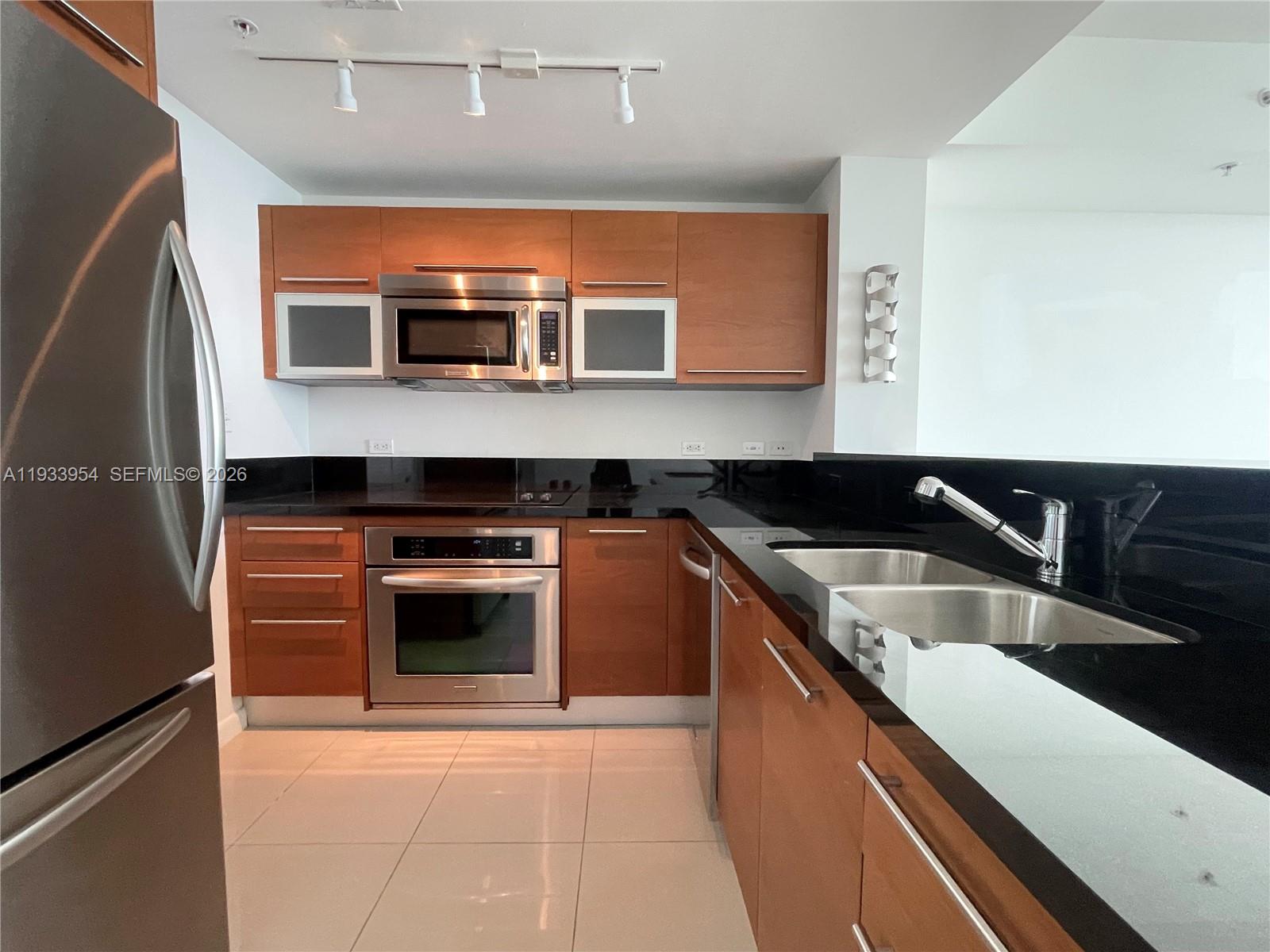 253 Northeast 2nd Street, Unit 2409 Miami, FL 33132 - Photo 14 of 61 a kitchen with stainless steel appliances granite countertop a stove and a sink