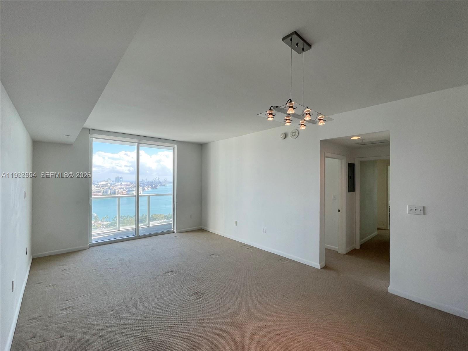 253 Northeast 2nd Street, Unit 2409 Miami, FL 33132 - Photo 18 of 61 a view of a livingroom with a chandelier