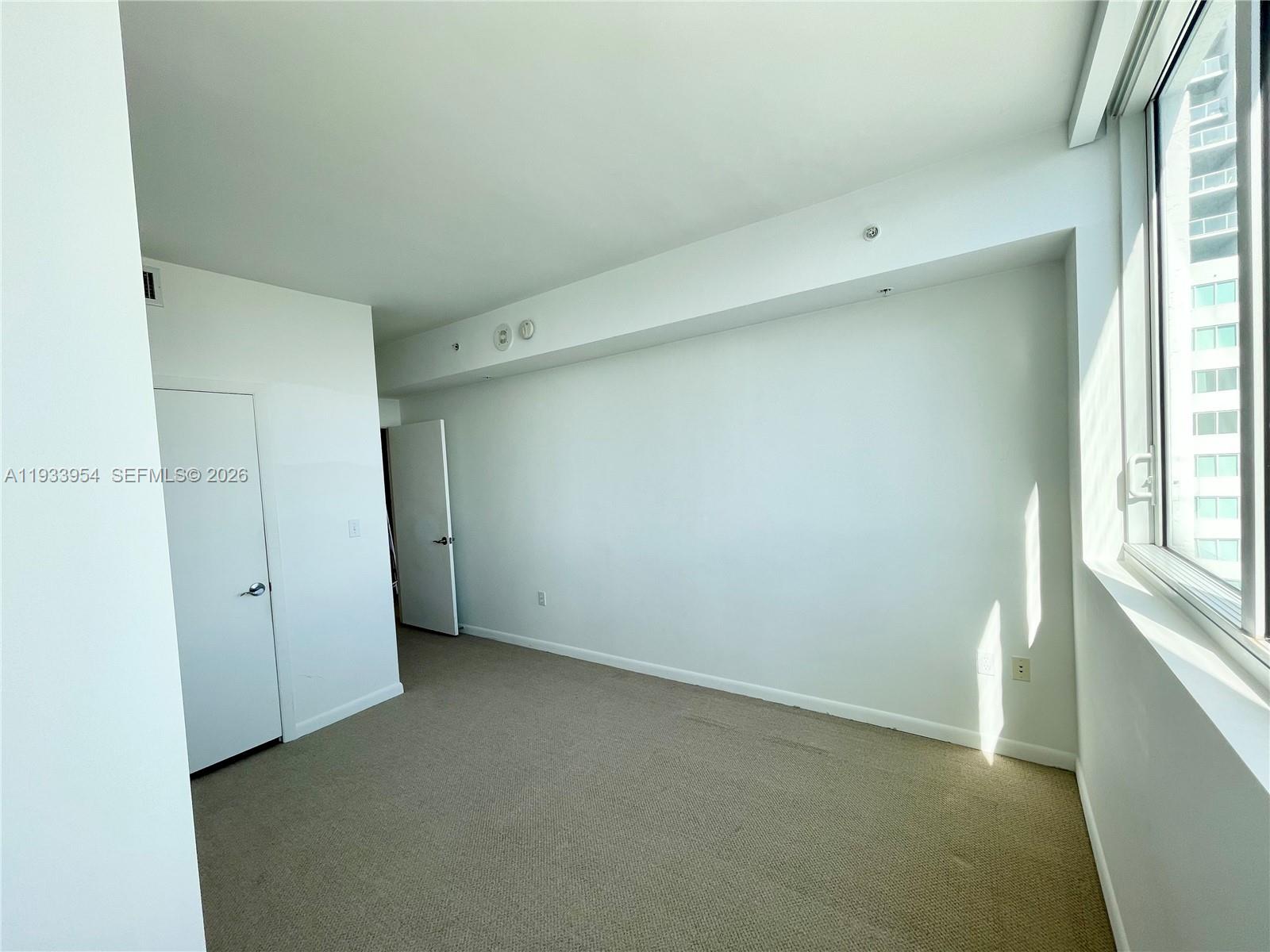 253 Northeast 2nd Street, Unit 2409 Miami, FL 33132 - Photo 28 of 61 a view of an empty room with a window