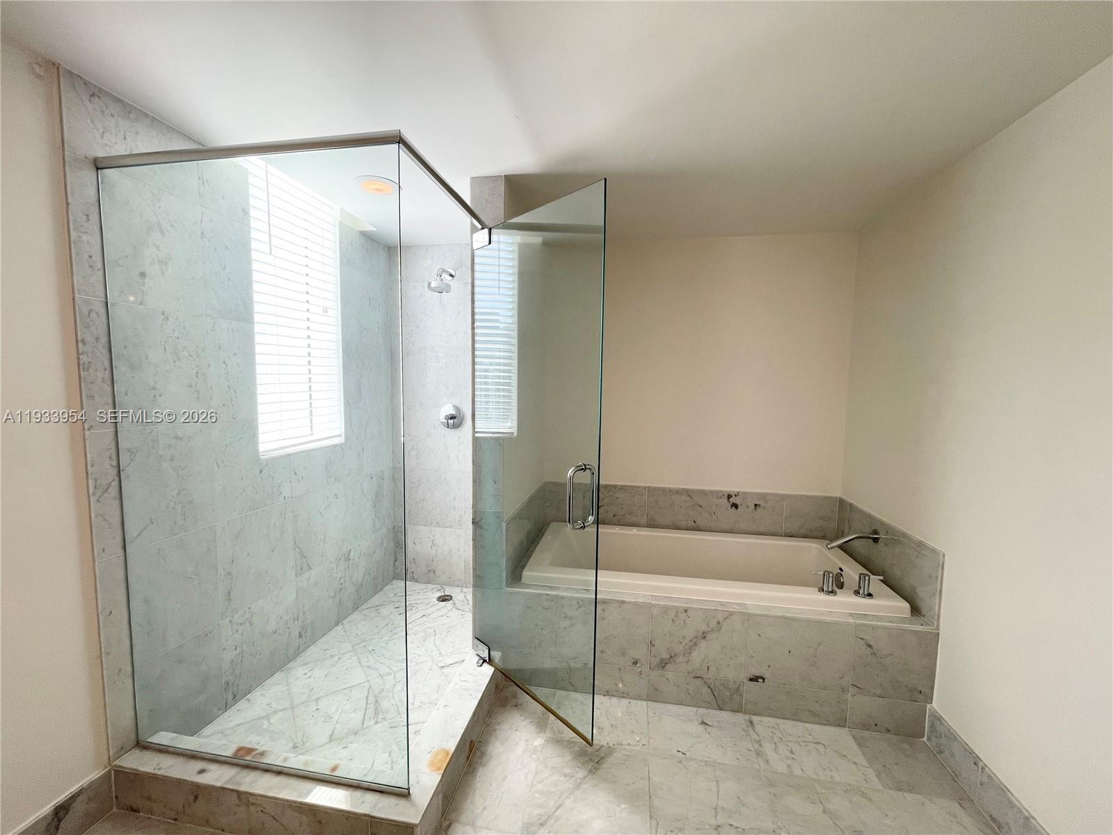253 Northeast 2nd Street, Unit 2409 Miami, FL 33132 - Photo 36 of 61 a bathroom with a bathtub and a shower