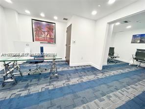 253 Northeast 2nd Street, Unit 2409 Miami, FL 33132 - Photo 46 of 61 a room with stainless steel appliances kitchen island granite countertop furniture and a view of kitchen