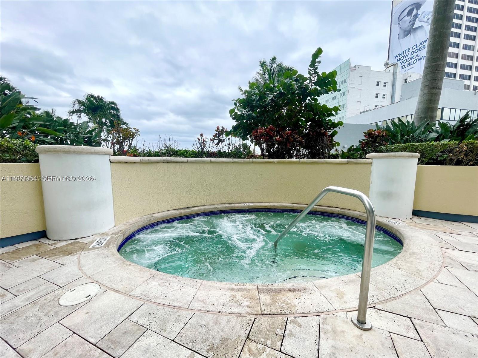 253 Northeast 2nd Street, Unit 2409 Miami, FL 33132 - Photo 52 of 61 a view of a swimming pool with a yard