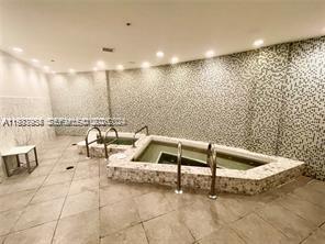 253 Northeast 2nd Street, Unit 2409 Miami, FL 33132 - Photo 58 of 61 a bathroom with a bathtub and a shower