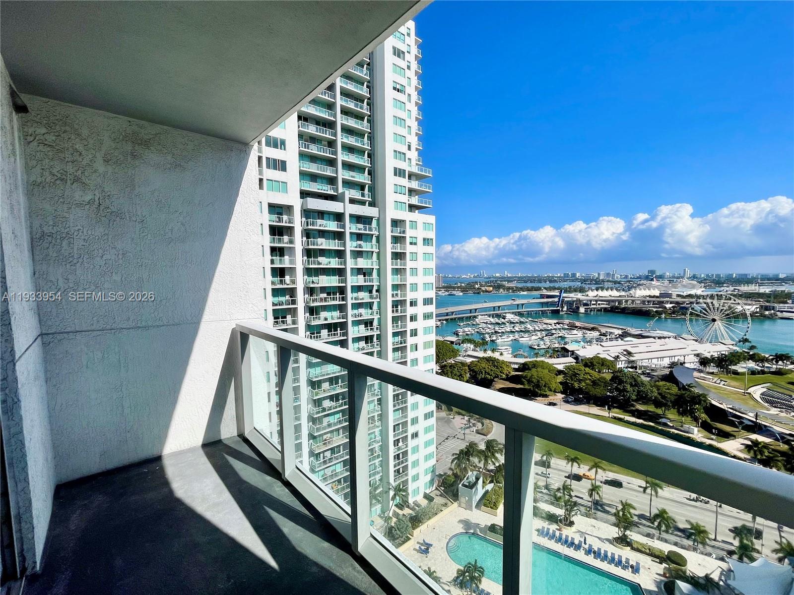 253 Northeast 2nd Street, Unit 2409 Miami, FL 33132 - Photo 6 of 61 a view of balcony with wooden floor and a potted plant