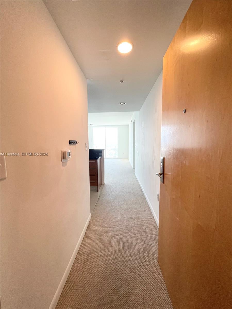 253 Northeast 2nd Street, Unit 2409 Miami, FL 33132 - Photo 9 of 61 a view of hallway with livingroom