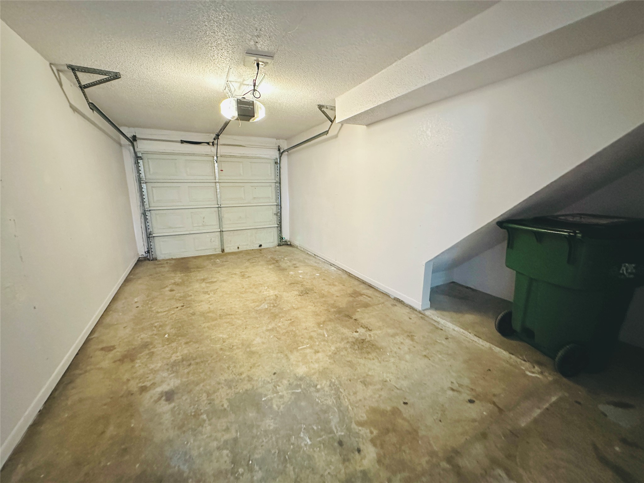 1002 Ridgemont Street Round Rock, TX 78664 - Photo 17 of 30 Garage featuring a garage door opener and baseboards