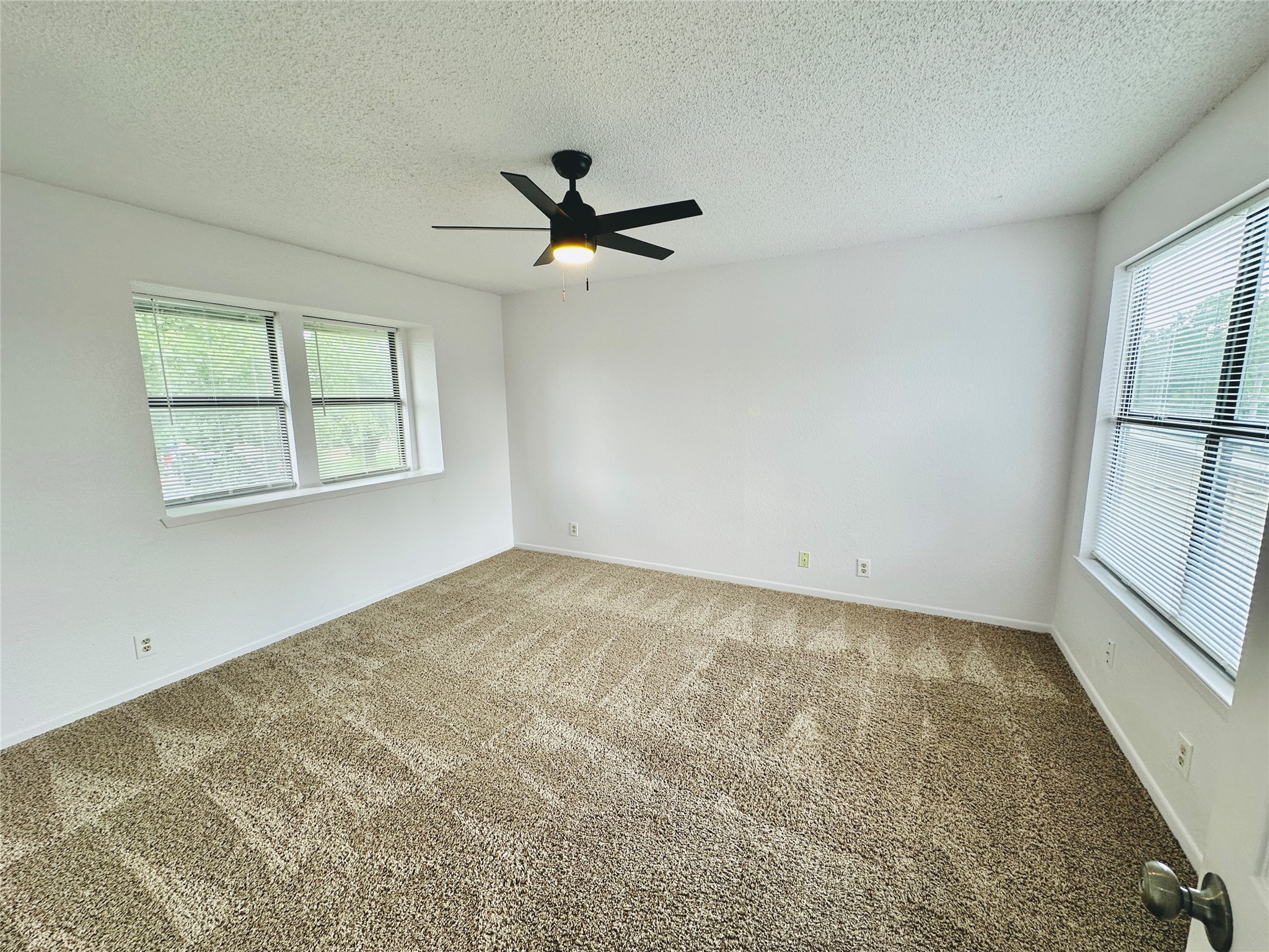 1002 Ridgemont Street Round Rock, TX 78664 - Photo 18 of 30 Carpeted empty room with a textured ceiling and a ceiling fan