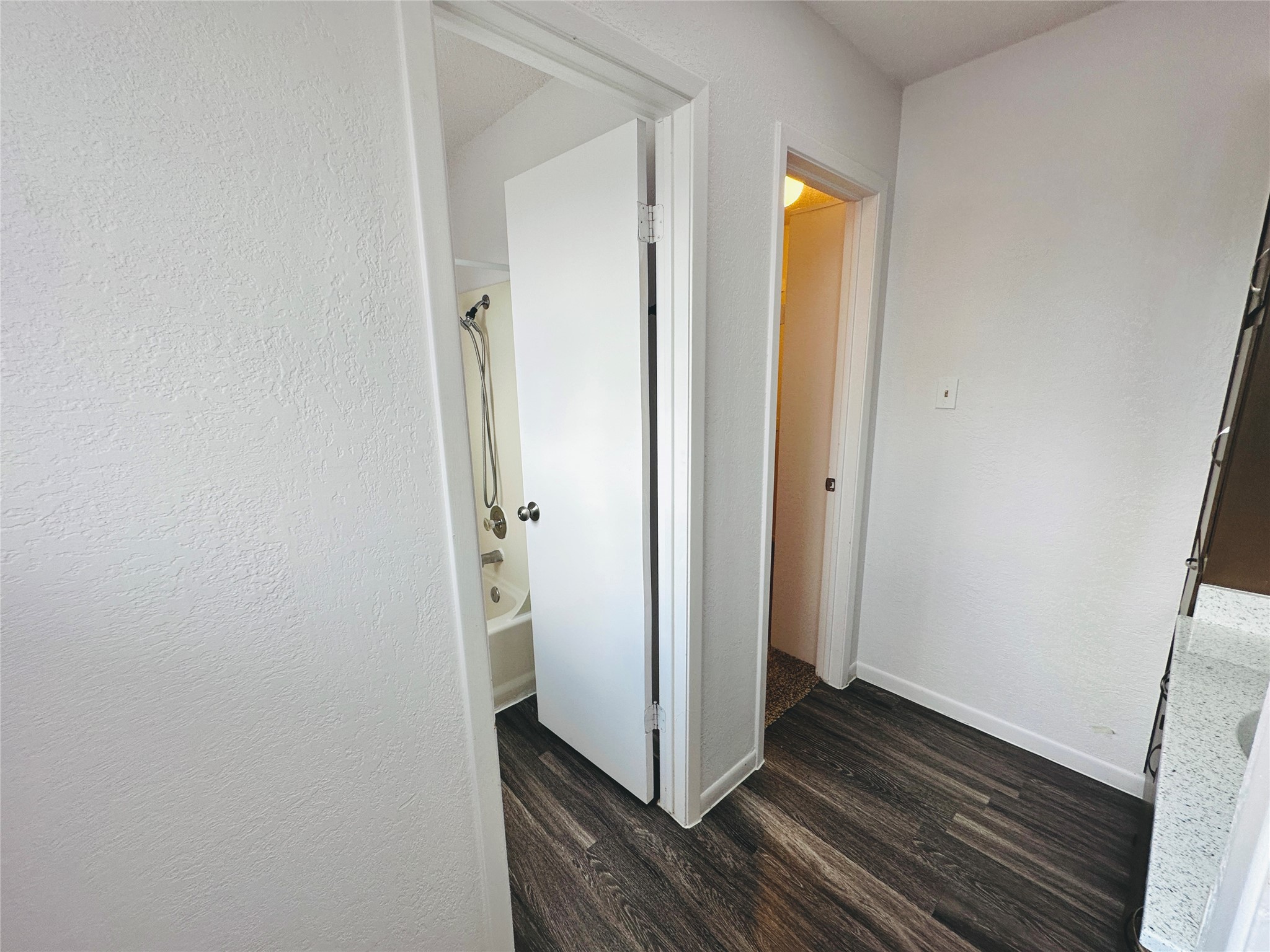 1002 Ridgemont Street Round Rock, TX 78664 - Photo 20 of 30 Corridor with dark wood finished floors and baseboards